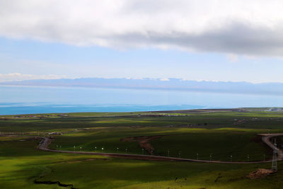 Scenic view of golf course against sky