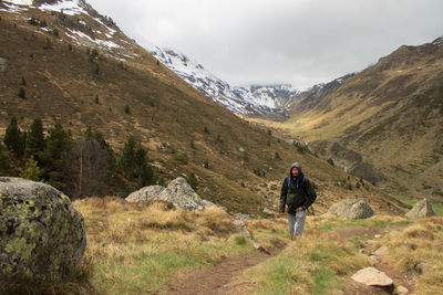 Rear view of man on mountain against sky