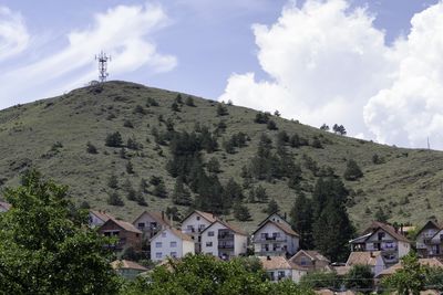 Houses on mountain against sky