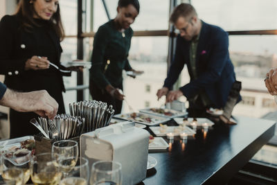 Male and female coworkers having food during office party