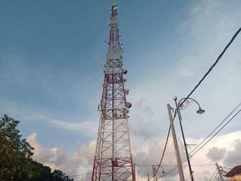 Low angle view of communications tower against sky