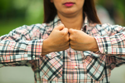 Midsection of woman wearing hat standing outdoors