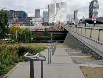 Footpath amidst buildings against sky in city