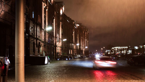 Illuminated city street at night