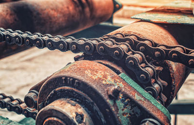 Parts of old broken transmission machine under corrosion close-up. rusty metal chain.