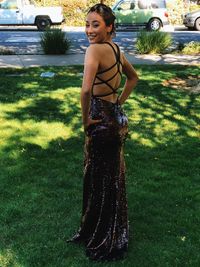 Portrait of smiling young woman standing on field