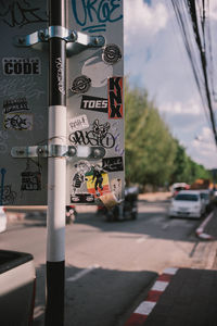 Close-up of road sign on street in city