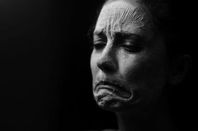 Close-up of young man against black background