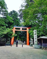 People at temple against trees