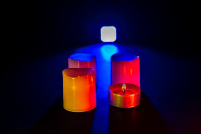 Close-up of illuminated bottle against black background