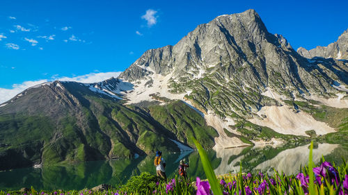 Low angle view of mountains against blue sky