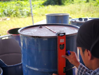 Close-up of man measuring barrel