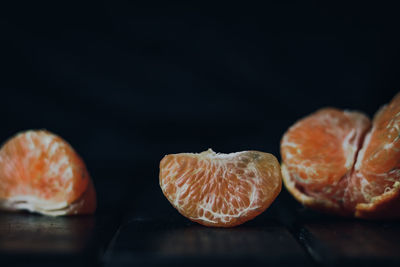 Close-up of orange slices against black background