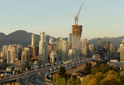 Aerial view of buildings in city against clear sky