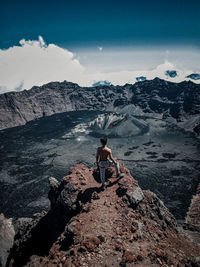 Full length of man on rock against sky