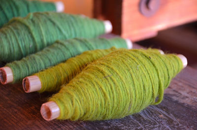 Close-up of multi colored spools on table