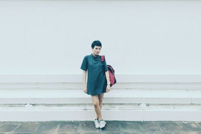 Young woman standing against clear sky