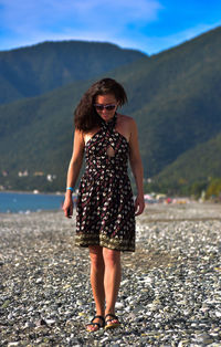 Full length portrait of woman standing on beach