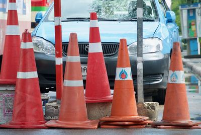 Close-up of traffic cones on street in city