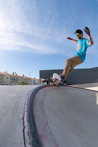 Full length of man skateboarding on road