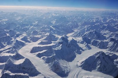 Aerial view of snowcapped mountains against sky