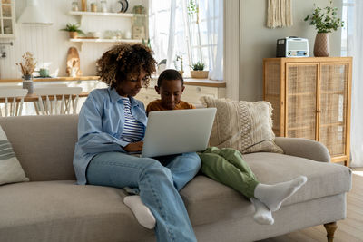 Young woman using laptop at home