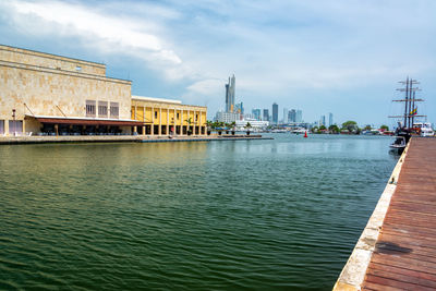 View of buildings in city against cloudy sky