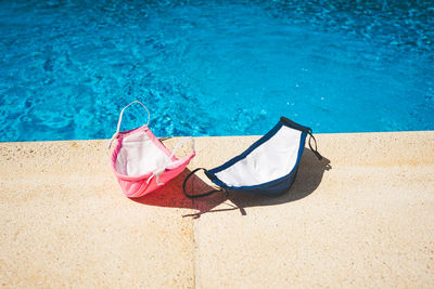 Lounge chairs by swimming pool at beach