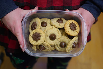 High angle view of hand holding cookies