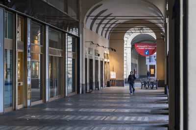 Woman walking in corridor of building