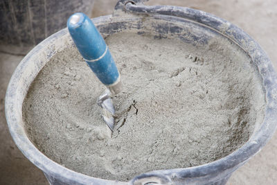High angle view of cement in bucket at construction site
