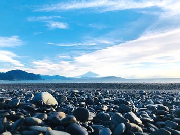 Rocks on beach against sky