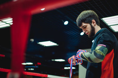 Side view of man wearing bondage in boxing ring