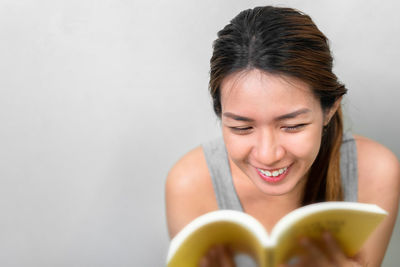 Portrait of a smiling young woman holding ice cream