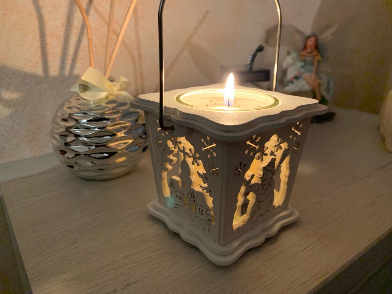 CLOSE-UP OF ILLUMINATED CANDLES ON TABLE