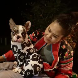 Portrait of woman with dog at home