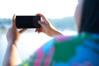 Man photographing through smart phone