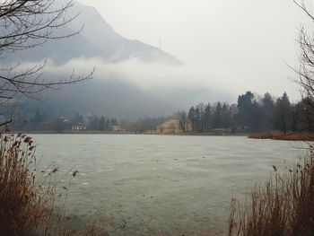 Scenic view of lake against sky during winter
