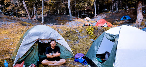 Rear view of a woman sitting on tent