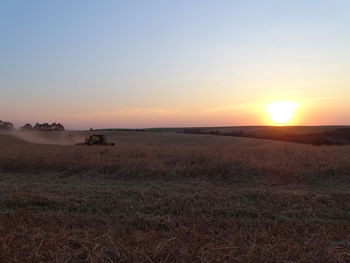 Scenic view of field against sky during sunset