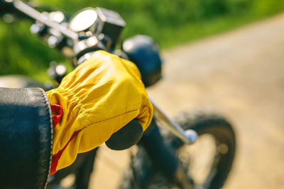 Close-up of man holding motorcycle handlebar