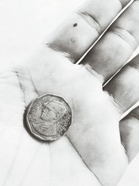 Close-up of hand holding coins