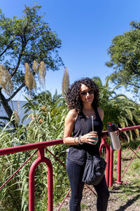 Tourist woman drinking a mate while exploring outdoors.