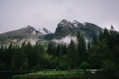 Scenic view of lake by mountain against sky