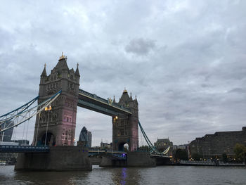 View of bridge over river against cloudy sky