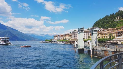 Scenic view of sea by buildings against sky