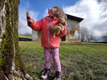 Full length of girl on field against sky