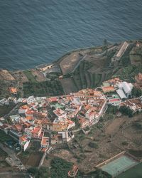 High angle view of townscape by sea