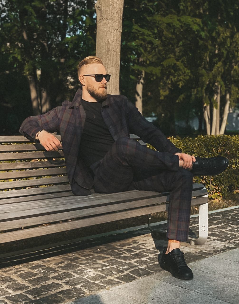 YOUNG MAN SITTING ON BENCH