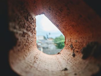 Close-up of hole in rusty metal